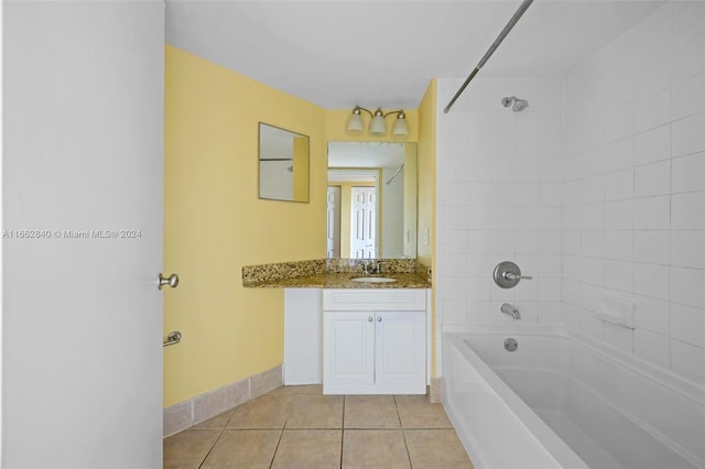 bathroom with tiled shower / bath, vanity, and tile patterned floors