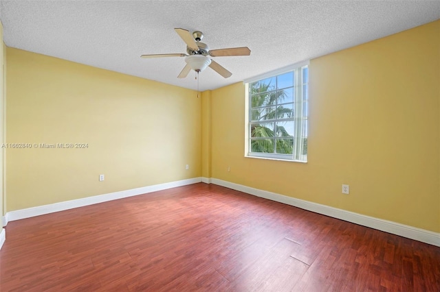 unfurnished room with ceiling fan, hardwood / wood-style flooring, and a textured ceiling