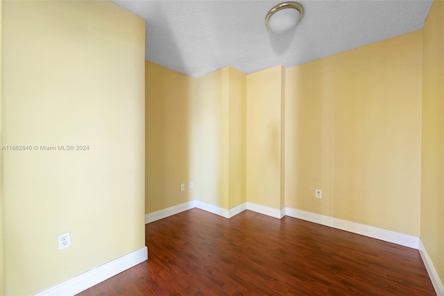 spare room with wood-type flooring and a textured ceiling