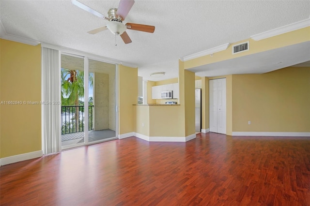 unfurnished room with ceiling fan, hardwood / wood-style flooring, ornamental molding, and a textured ceiling