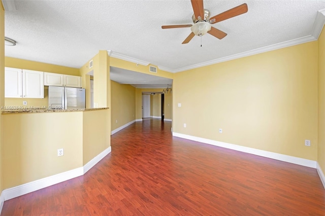 unfurnished living room with a textured ceiling, crown molding, dark hardwood / wood-style floors, and ceiling fan