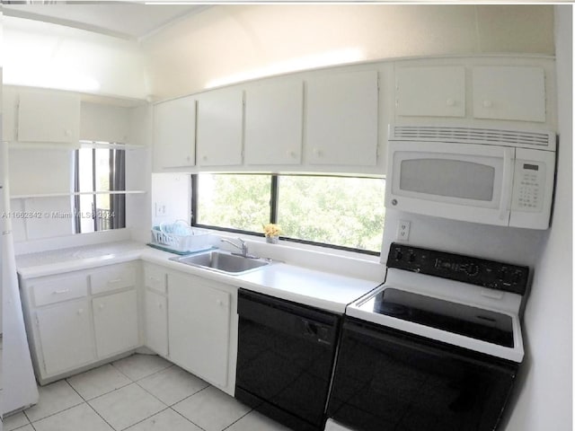 kitchen featuring light tile patterned floors, white cabinets, sink, and white appliances