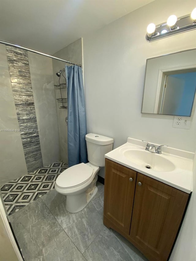 bathroom featuring toilet, vanity, and walk in shower