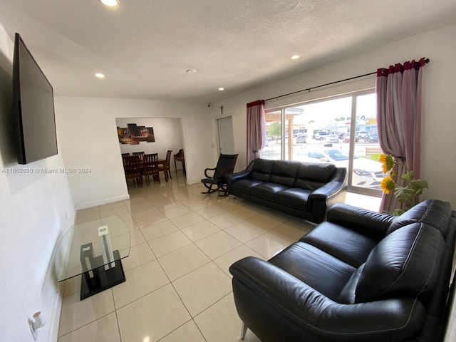 tiled living room with a textured ceiling