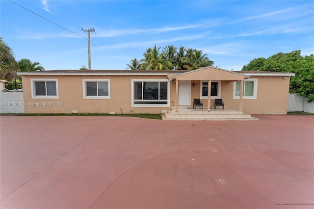 back of property with a patio