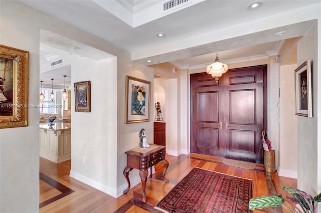 9801 NW Collins Ave Unit Ph8, Bal Harbour, FL 33154 - foyer with light wood-style floors, baseboards, crown molding, and visible vents