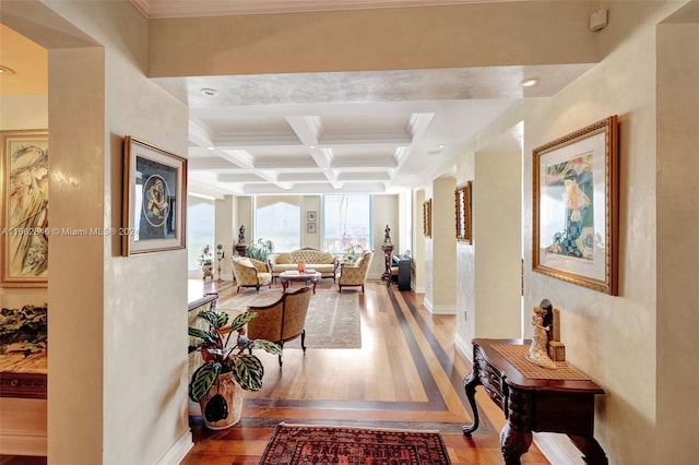 hall with wood-type flooring, crown molding, beam ceiling, and coffered ceiling