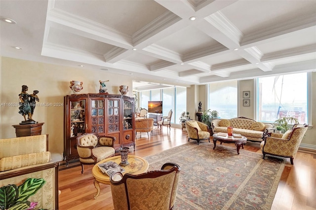 interior space featuring coffered ceiling, ornamental molding, light hardwood / wood-style flooring, and beam ceiling