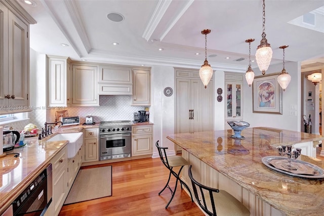 kitchen featuring high end stainless steel range, pendant lighting, light hardwood / wood-style floors, and a breakfast bar