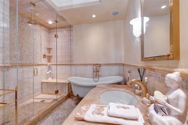 bathroom featuring sink, tile walls, and shower with separate bathtub