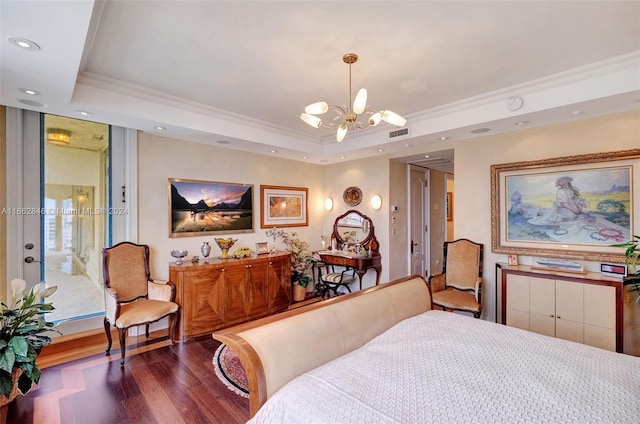 bedroom with crown molding, a chandelier, dark hardwood / wood-style floors, and a raised ceiling