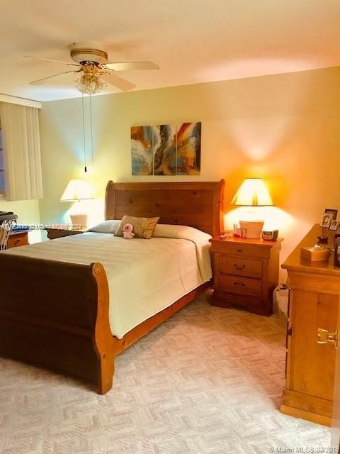 bedroom featuring ceiling fan and light colored carpet