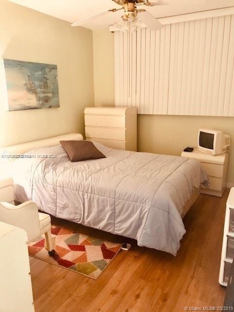 bedroom with ceiling fan and hardwood / wood-style floors