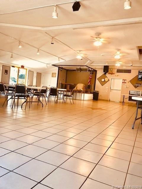 dining space with ceiling fan and light tile patterned floors