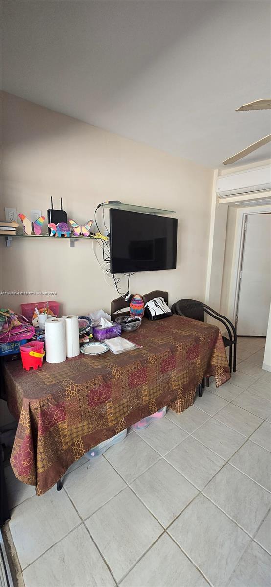 interior space featuring a wall mounted air conditioner and tile patterned flooring