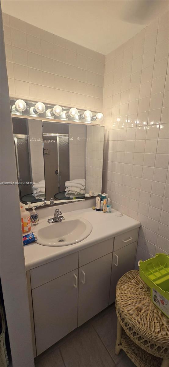 bathroom featuring tile walls, vanity, and tile patterned floors