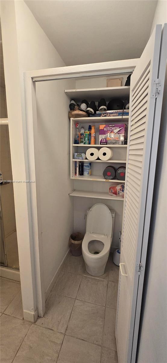 bathroom with toilet and tile patterned floors