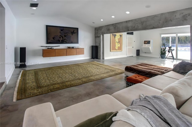 living room featuring vaulted ceiling and concrete floors