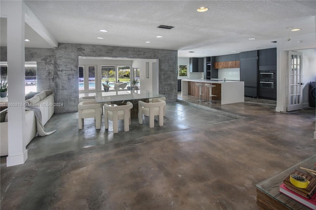 interior space with french doors and a textured ceiling