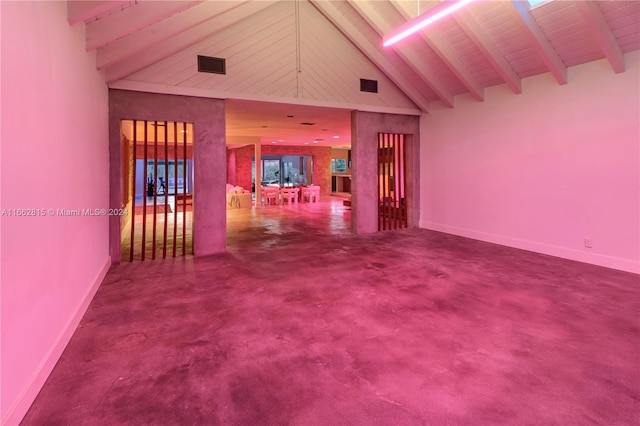 spare room featuring beamed ceiling and high vaulted ceiling