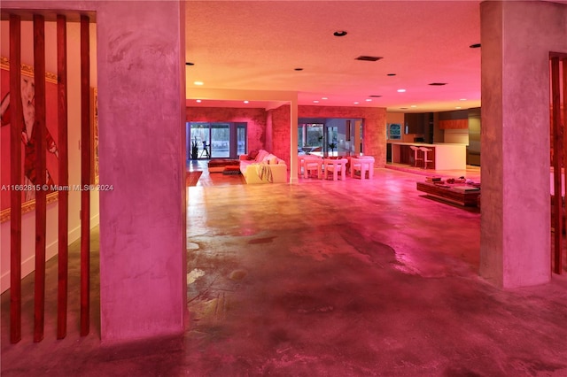 interior space with concrete flooring and a textured ceiling