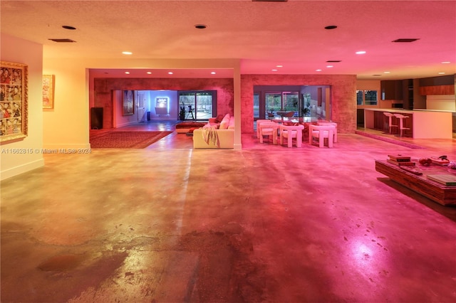 interior space with a textured ceiling and concrete floors