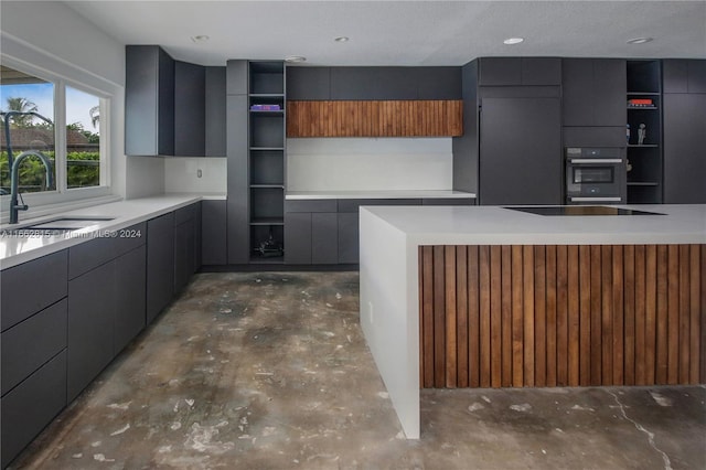 kitchen featuring sink, a textured ceiling, and black electric stovetop