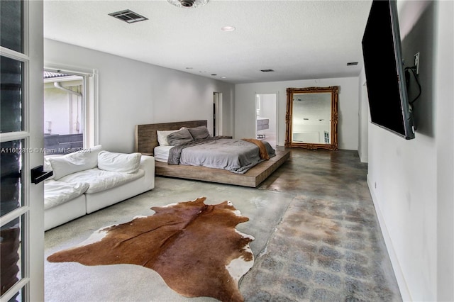 bedroom featuring concrete flooring and a textured ceiling