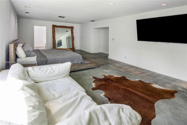 bedroom featuring concrete flooring and a textured ceiling