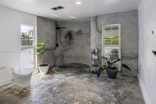 bathroom featuring walk in shower and toilet