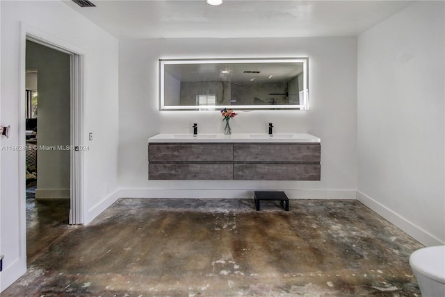 bathroom with toilet, a shower with door, vanity, and concrete floors