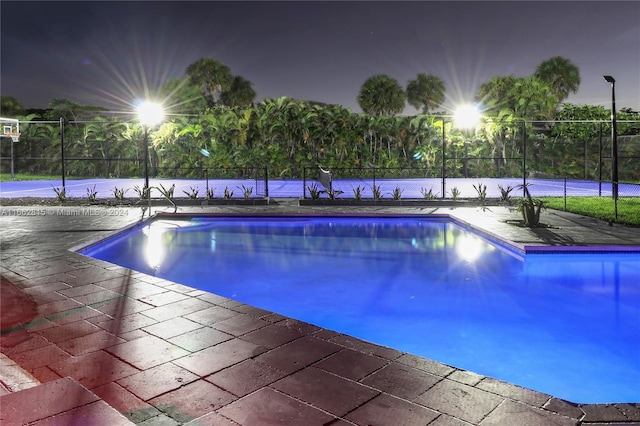 pool at twilight with a patio