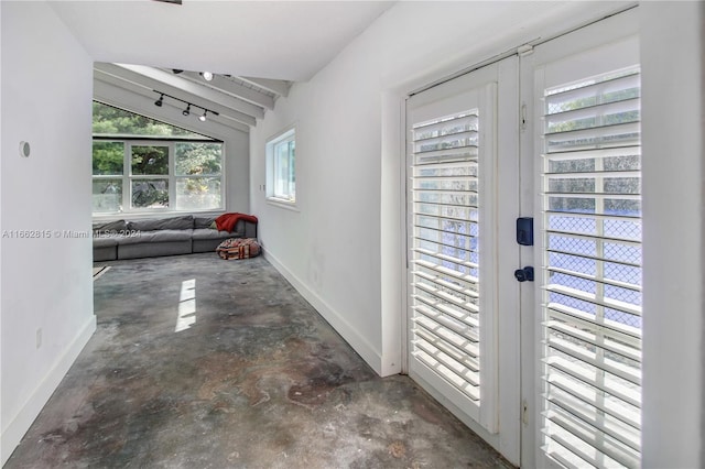 hall featuring lofted ceiling