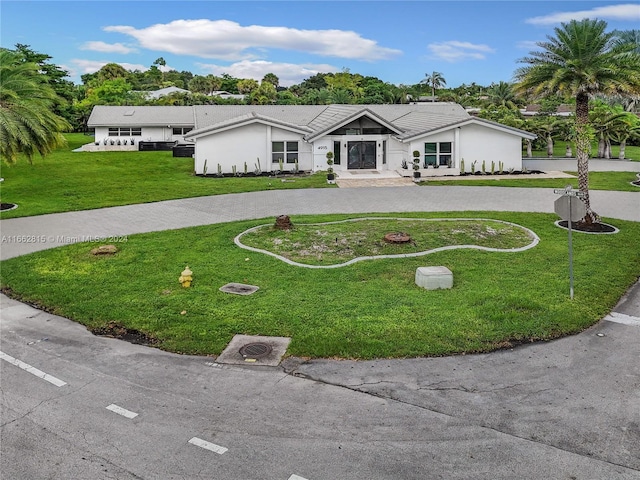 ranch-style house featuring a front lawn