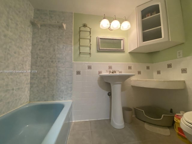 bathroom with tile walls, tile patterned flooring, shower / tub combination, and toilet