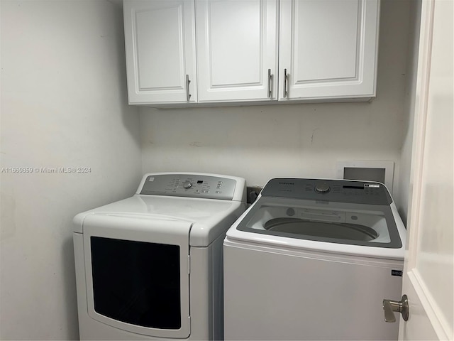 washroom with cabinets and separate washer and dryer