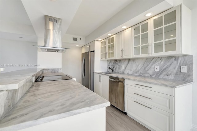 kitchen featuring tasteful backsplash, visible vents, glass insert cabinets, island exhaust hood, and stainless steel appliances