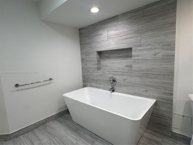 bathroom with tile walls and a washtub