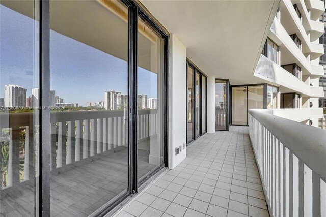 empty room featuring a wall of windows and dark hardwood / wood-style flooring