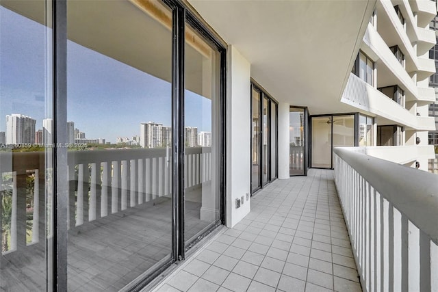 spare room featuring baseboards, a city view, dark wood finished floors, and floor to ceiling windows