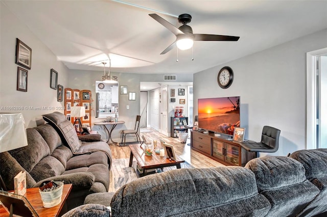 living room with hardwood / wood-style floors and ceiling fan