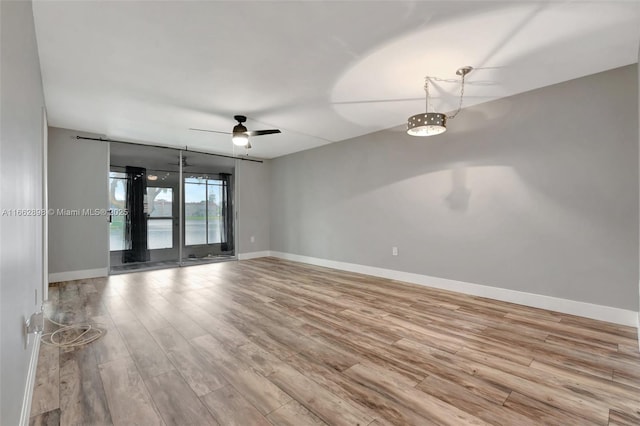 unfurnished room featuring light hardwood / wood-style floors and ceiling fan