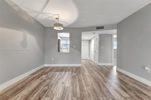 spare room with wood-type flooring