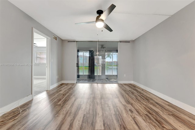 unfurnished room featuring wood-type flooring and ceiling fan
