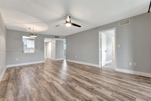 interior space with ceiling fan and light colored carpet