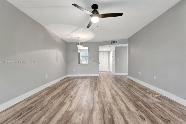 empty room featuring hardwood / wood-style floors and ceiling fan