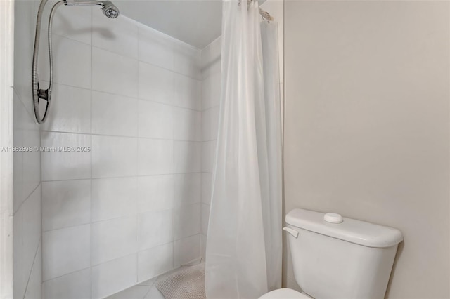 bathroom featuring a shower with curtain and toilet