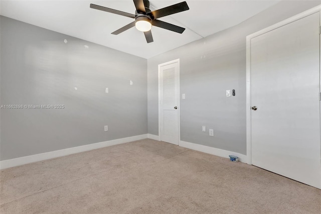 carpeted spare room with ceiling fan