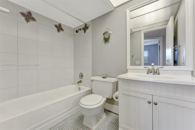 full bathroom featuring tiled shower / bath combo, vanity, tile patterned floors, and toilet
