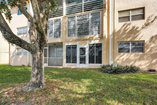 rear view of property with a lawn